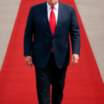 Donald Trump walks on a red carpet during his formal arrival for the Donald Trump state visit UK.